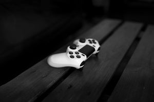 White gaming controller on wooden table