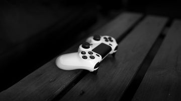 White gaming controller on wooden table