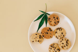 Cannabis leaf with cookies on plate