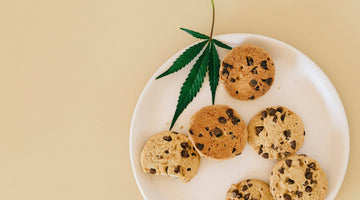 Cannabis leaf with cookies on plate