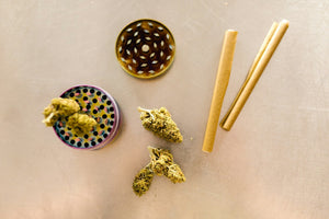Cannabis, grinder, and rolling papers setup