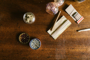 Rolling papers and cannabis on wooden table