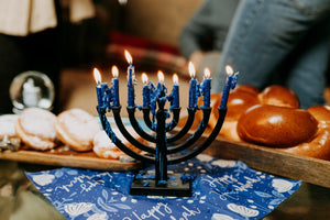Hanukkah menorah with blue candles lit