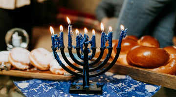Hanukkah menorah with blue candles lit