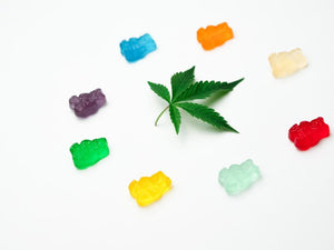 Gummy bears circling a cannabis leaf