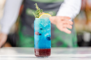 Colorful layered drink with lemon and berries