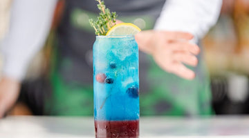 Colorful layered drink with lemon and berries