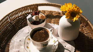Cup of coffee, sweets, and yellow flowers