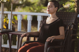 Woman sitting calmly in a chair outside
