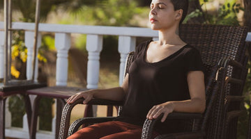 Woman sitting calmly in a chair outside
