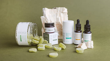 Various CBD products and gummies on green background