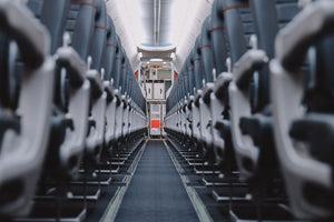 View down aisle of empty airplane seats