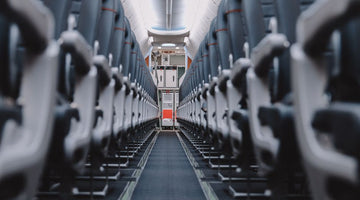 View down aisle of empty airplane seats
