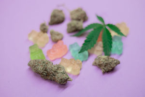 Weed buds, gummies, and cannabis leaf on purple