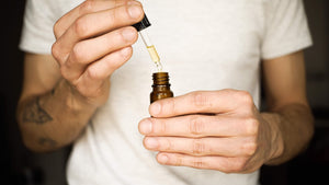 Person using dropper with brown bottle