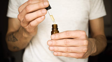 Person using dropper with brown bottle