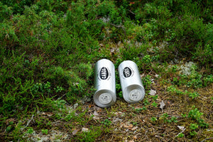 Two silver cans in green foliage
