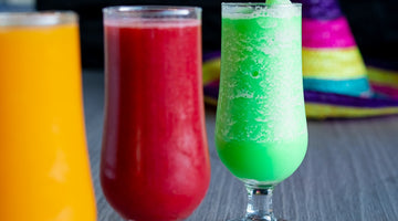 Three colorful drinks with a sombrero in background